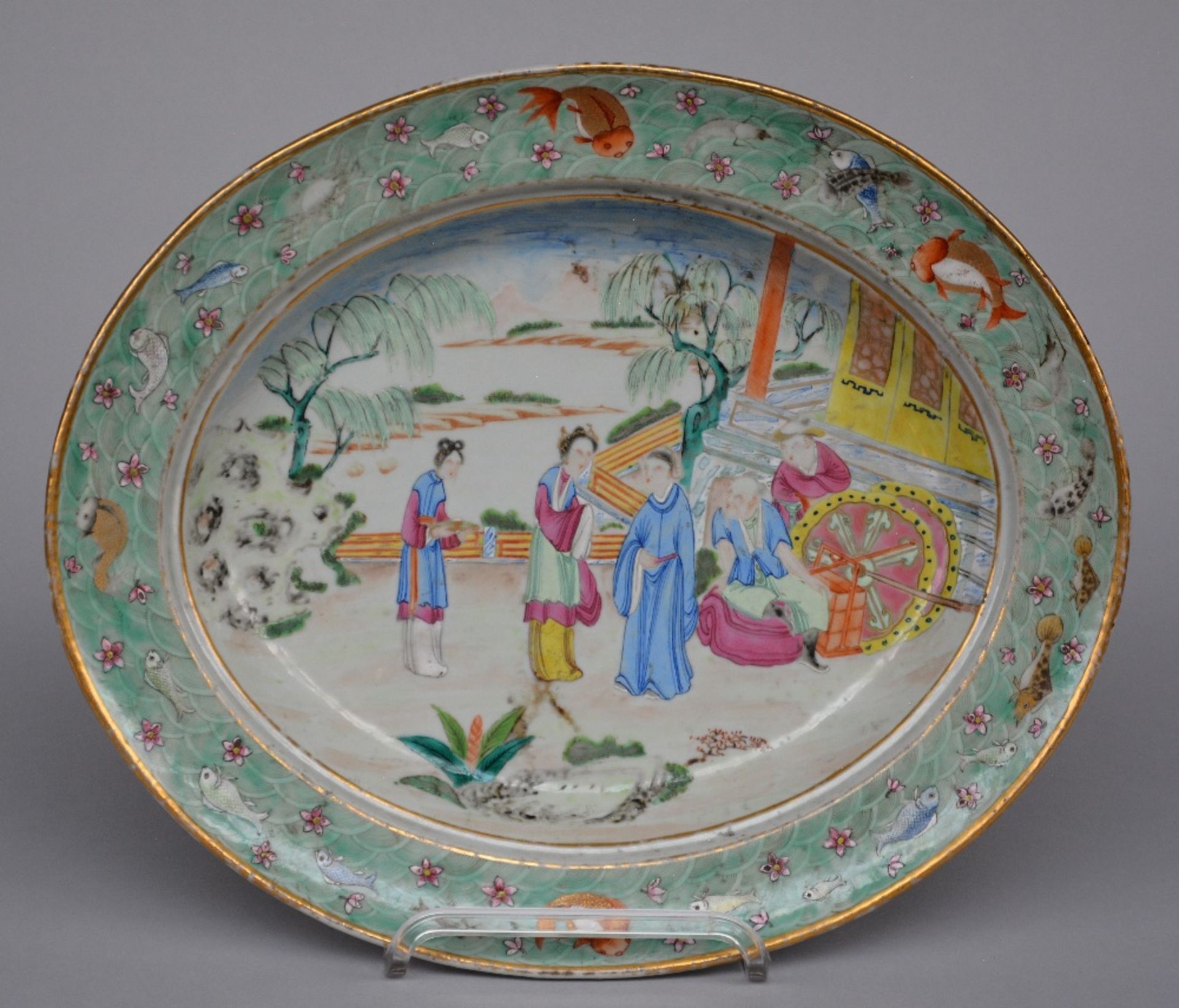An exceptional Chinese oval dish, famille rose, decorated with a genre scene and fish, 18thC, H