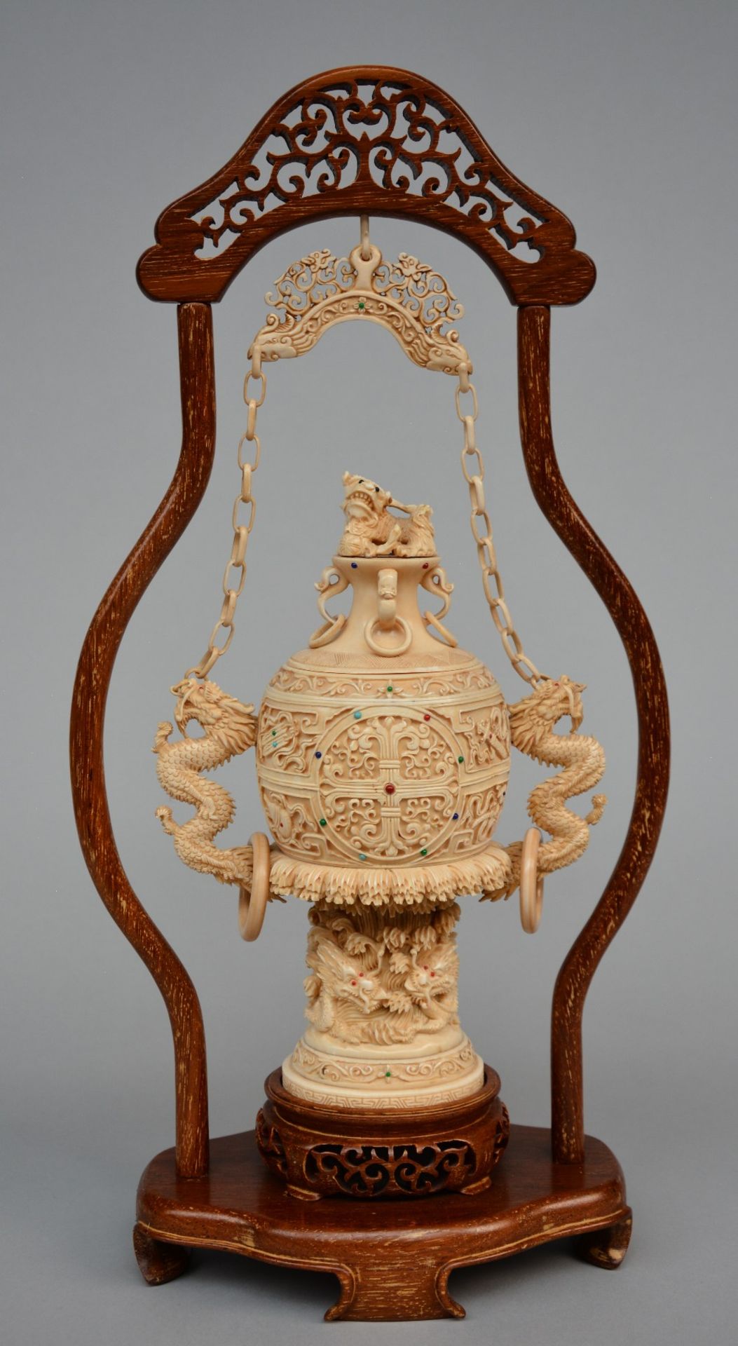A Chinese ivory vase with cover with relief decoration of dragons, inlaid with various precious
