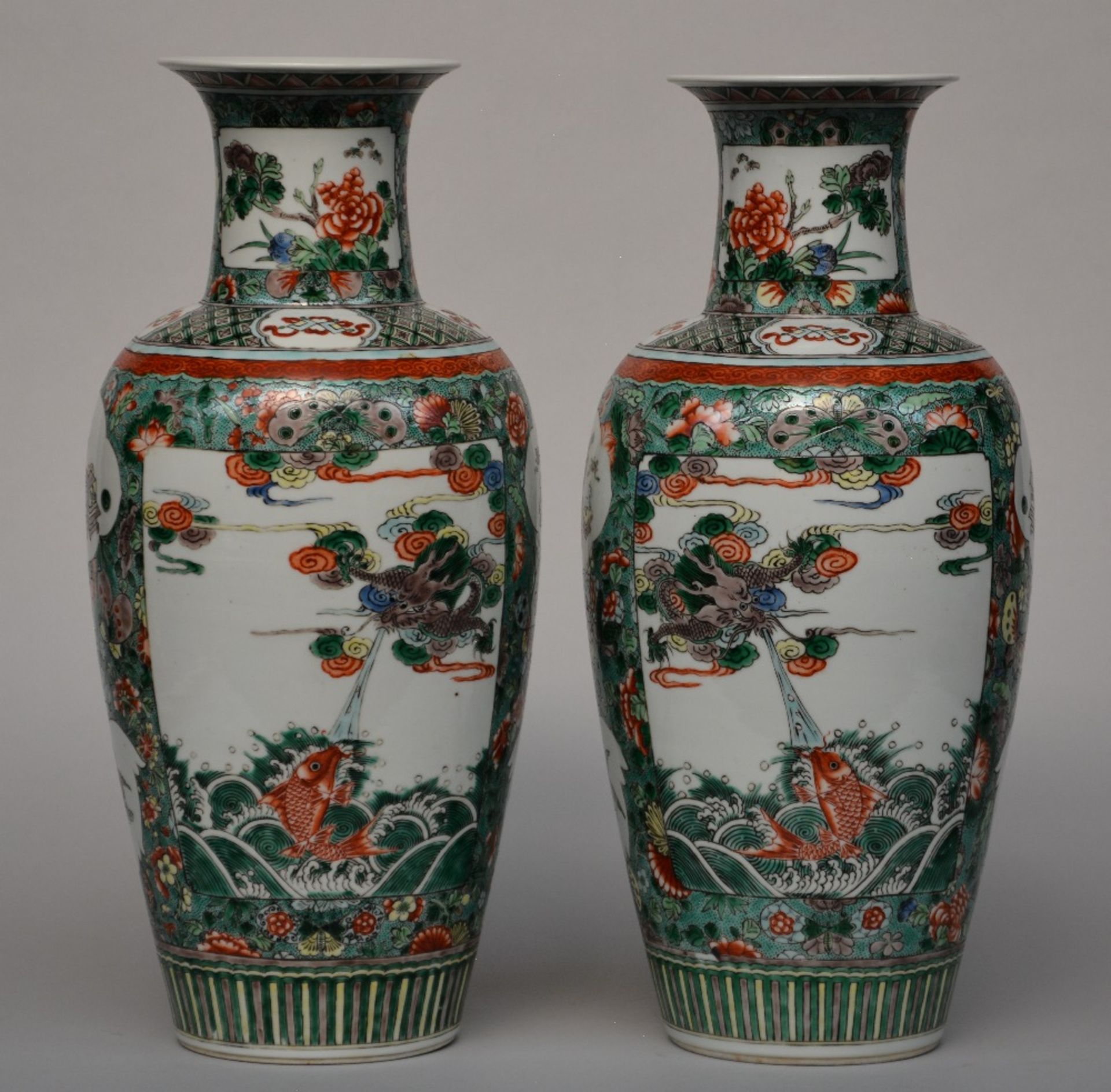 A pair of Chinese famille verte vases decorated with floral motifs, fish and a dragon, H 45 - 45,5