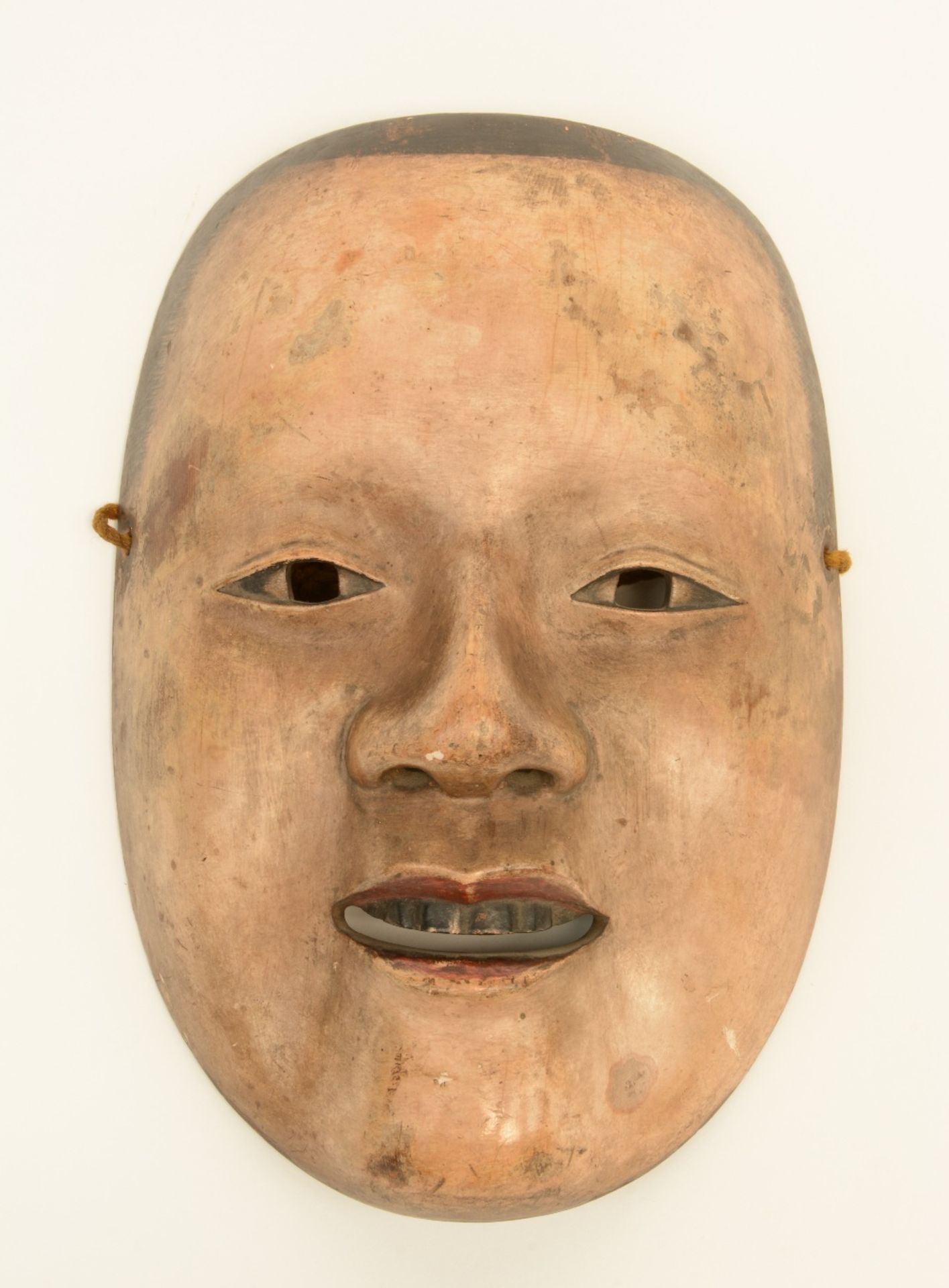 An 18thC lacquered cypress wood Noh theater mask, inside with the name of the character and the