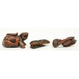 Two Japanese wooden katabori netsuke, one depicting a mythical monster and one depicting a (snail)