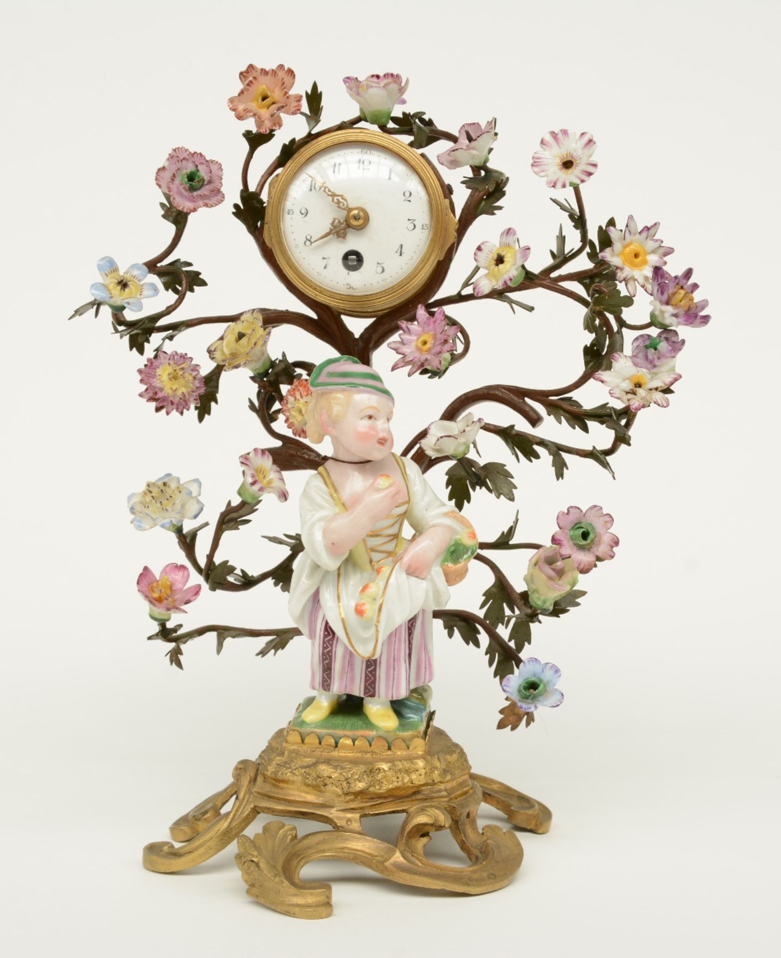 A charming Rococo style mantelclock in the Berlin manner, the bronze mounts gilded and polychrome