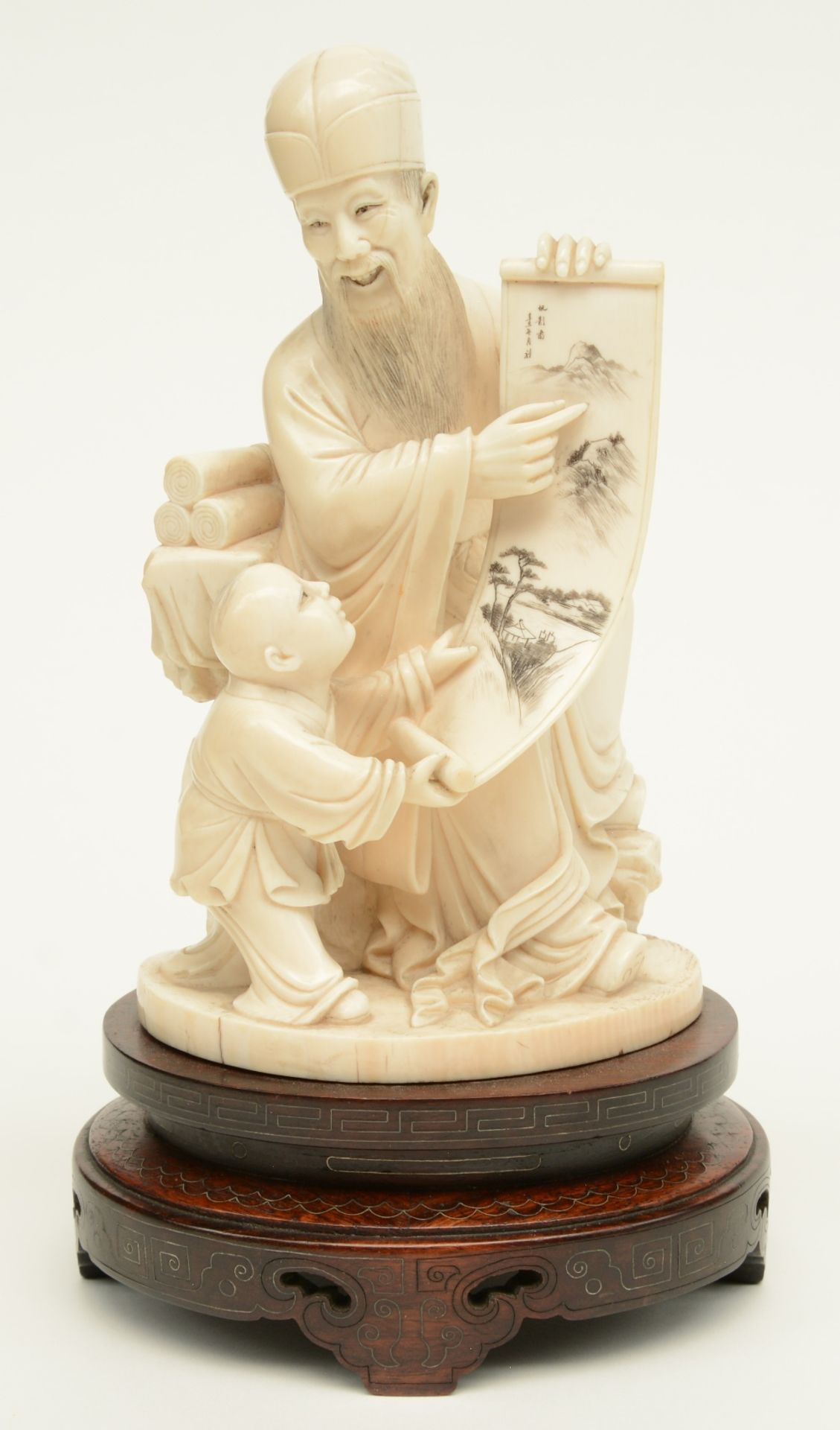 A late Qing dynasty ivory sculpture depicting a sage and his young pupil, refined scrimshaw