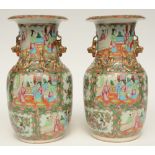 A pair of Chinese Canton vases with relief decorations, H 35,5 cm (one vase with chip on the rim;