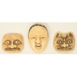 Three early Meiji period Japanese ivory netsuke in the form of masks, one of them a Noh theater