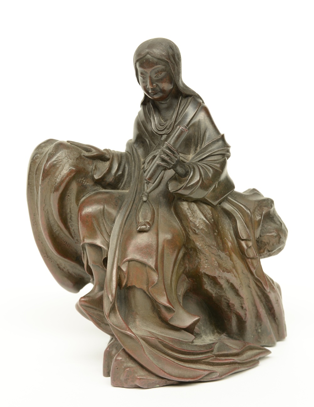 A Chinese bronze Guanyin sitting on a rock, 19thC, H 16 cm