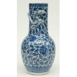 A Chinese blue and white and relief decorated vase, 19thC, H 44,5 cm (crack and whole in the bottom,
