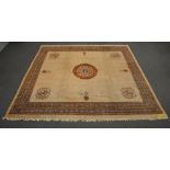 A Tibetan rug, floral decorated, the roundels with mythical animals, 427 x 446,5 cm (restoration,