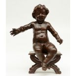 A late 17thC sculpted oak putto, mounted on a walnut bench (later date), H 73 cm