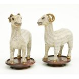 A pair of Chinese cloisonné figures depicting goats, on a wooden base, 19thC, H 16,5 cm (with