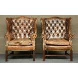 A pair of Chesterfield wingchairs, with brown leather upholstering, H 102,5 - W 79,5 - D 72 cm