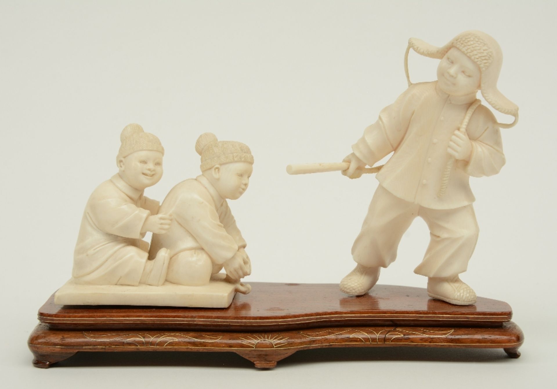 A Chinese ivory group depicting a winter scene with playing children, first half 20thC, H 7,5 - 12,4