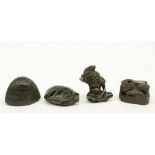 Four Japanese ebony netsuke depicting: one a man with a toad, signed; one a cottage in a