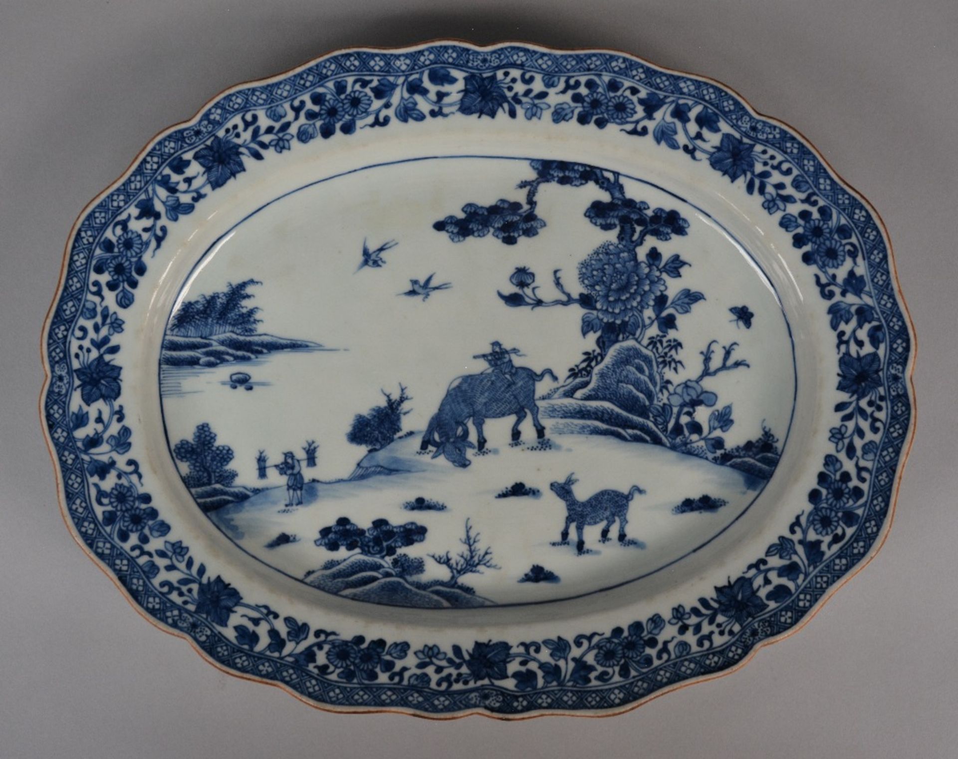 A Chinese oval dish with profiled rim, blue and white decorated with a landscape and floral - Image 5 of 5