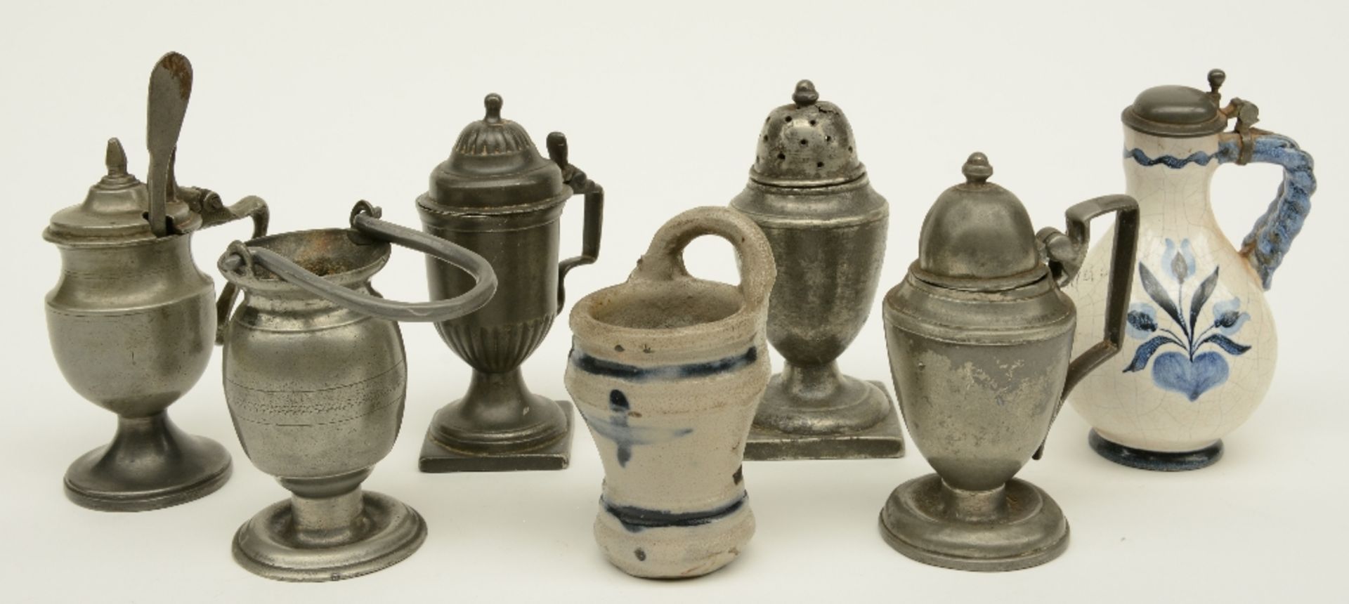 A lot: three pewter mustard pots, a caster and a Holy Water font, some marked, 18thC; added a