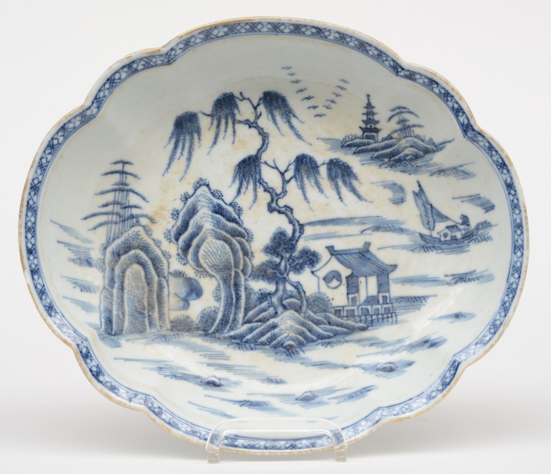 A Chinese oval dish with a profiled rim, blue and white decorated with a landscape, 18thC,