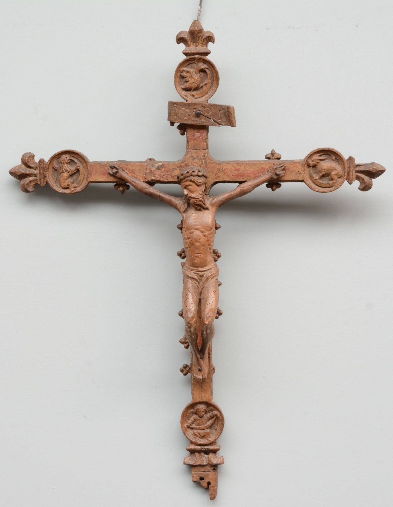 A 16thC oak crucifix, the cross decorated with animals from the Bestiary, traces of polychromy,