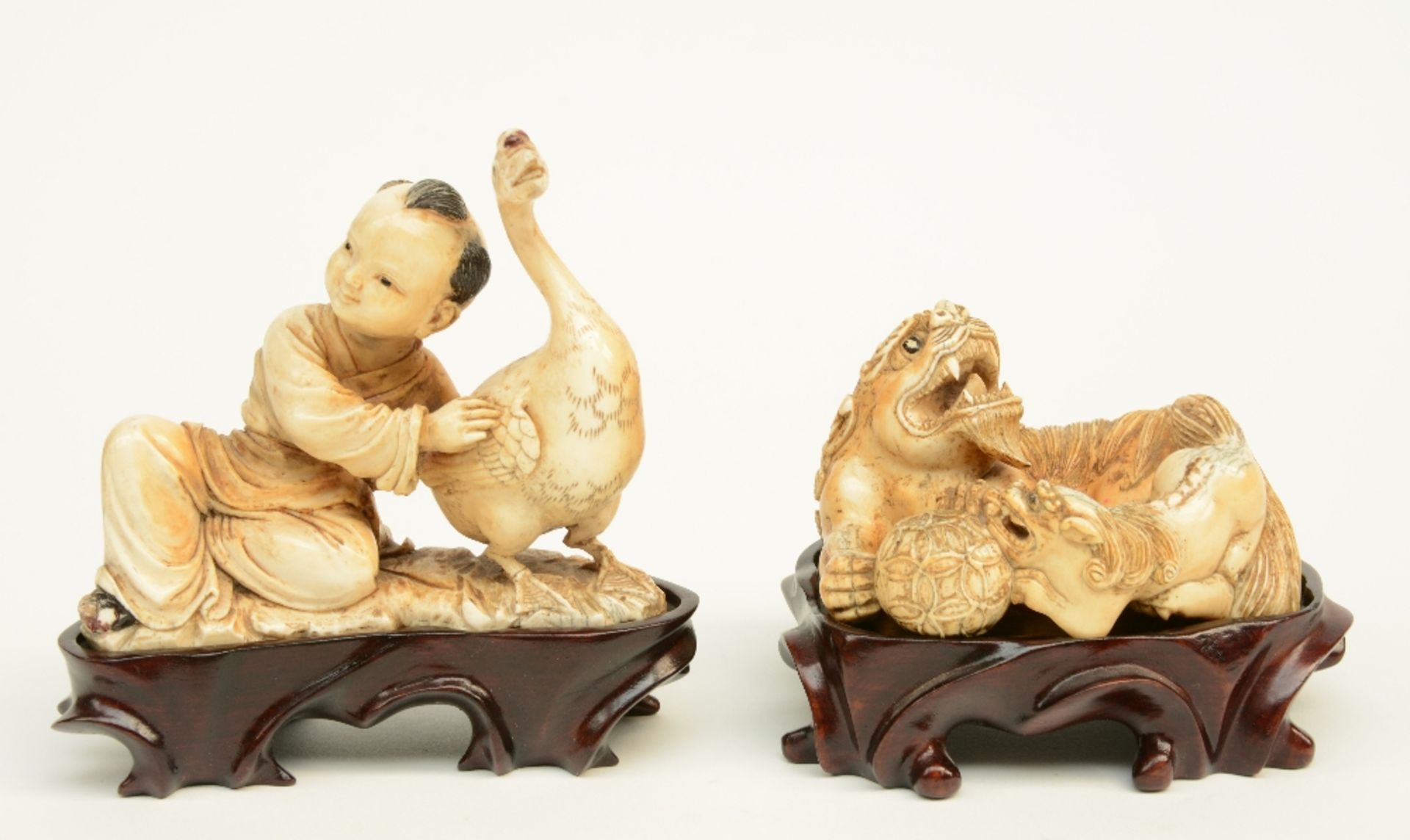 Two Chinese mammut ivory sculptures, polychrome and gilt decorated, one depicting a child and goose,