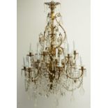 An impressive gilt bronze and crystal crown chandelier, the lower central part decorated with putti,