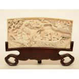 A Chinese ivory plaque on a wooden base depicting the Eight Immortals crossing the sea, Republic