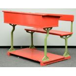 A red lacquered pitchpine and cast iron school desk, H 90 - W 120,5 - D 85,5 cm