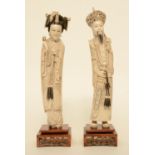 A pair of Chinese ivory figures of the imperial couple, on a fixed wooden base, scrimshaw decorated,