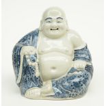 A Chinese blue and white decorated laughing Buddha, marked, H 17 cm