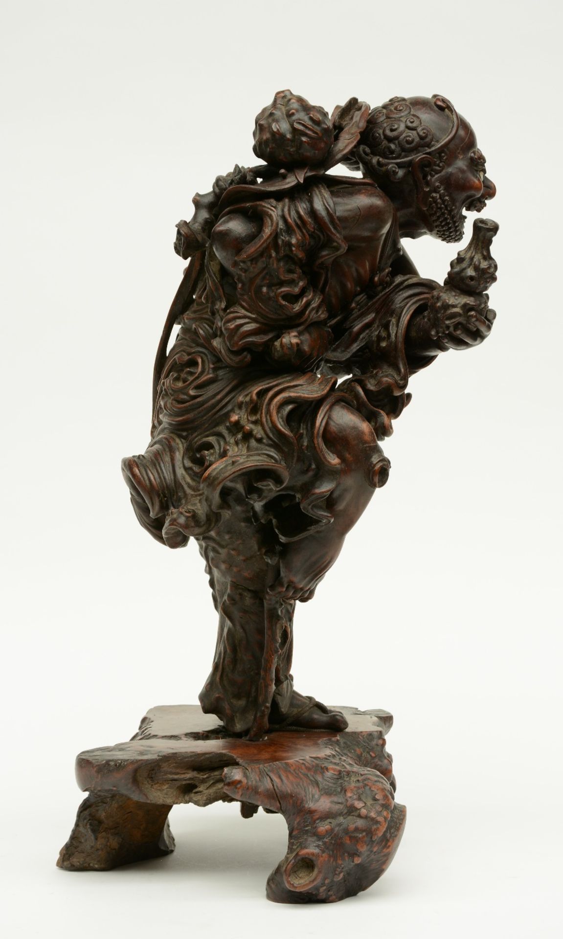 A Chinese walnut carved sculpture depicting a mythical figure, 19thC, H 64 cm (left indexfinger - Image 4 of 4