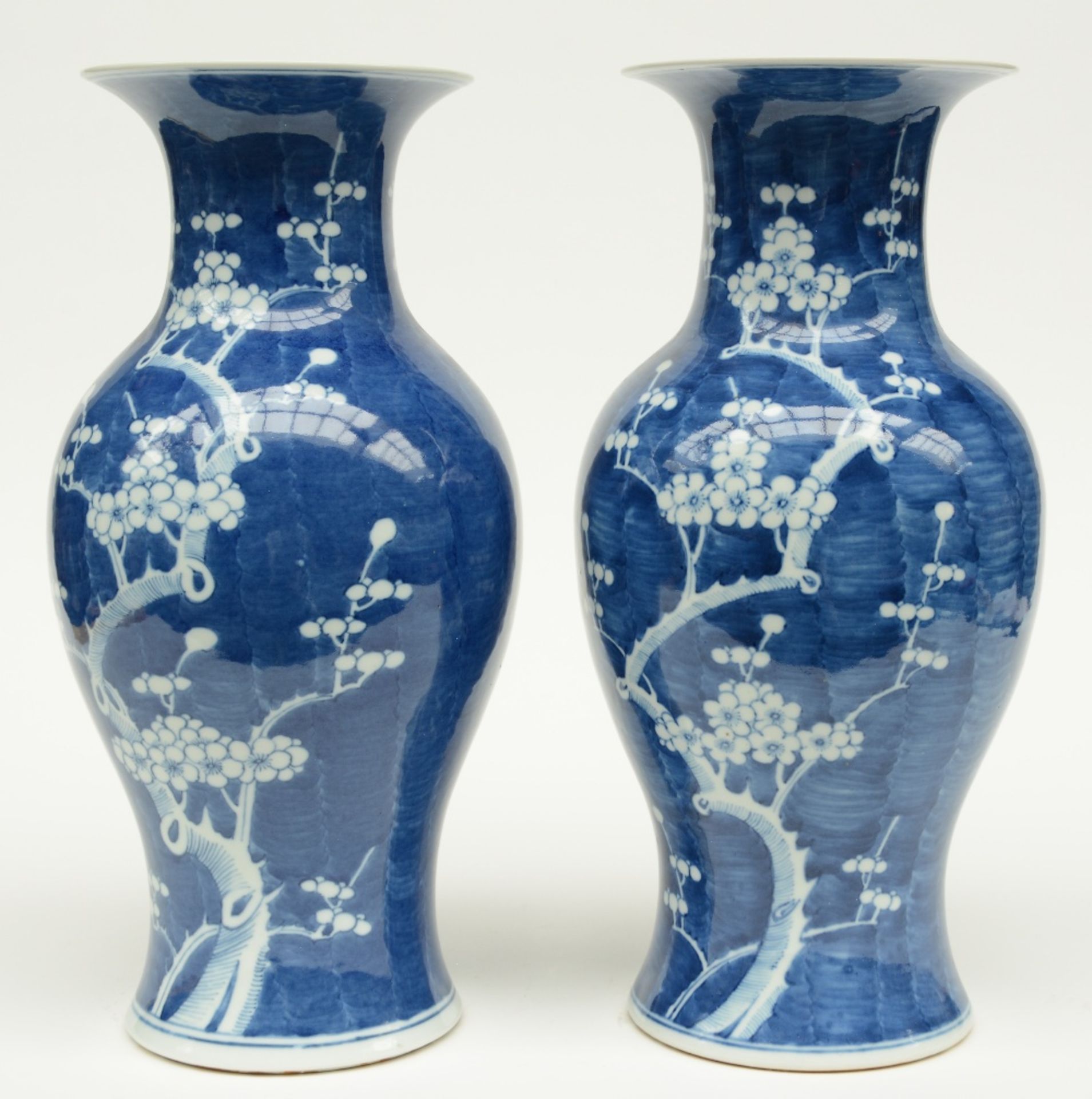 A pair of Chinese blue and white decorated vases painted with prunus blossoms, H 42,5 cm - Image 3 of 6