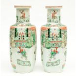 A fine pair of Chinese rouleau shaped vases, famille verte overall decorated with an animated scene,