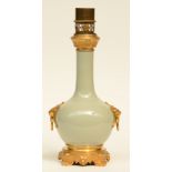 A Chinese celadon bottle vase, with gilt bronze and brass mounts, mounted into a lamp, H 45 cm