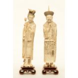 A pair of Chinese ivory dignitaries, on wooden base, late 19thC, H 37,5 - 39,5 cm - Weight: ca. 1129