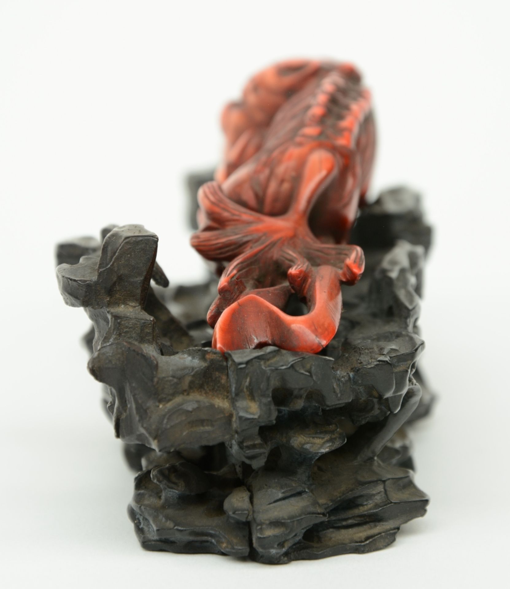 A Chinese monochrome red ivory sculpture depicting a mythological animal, on a wooden base, 19thC, H - Bild 2 aus 8