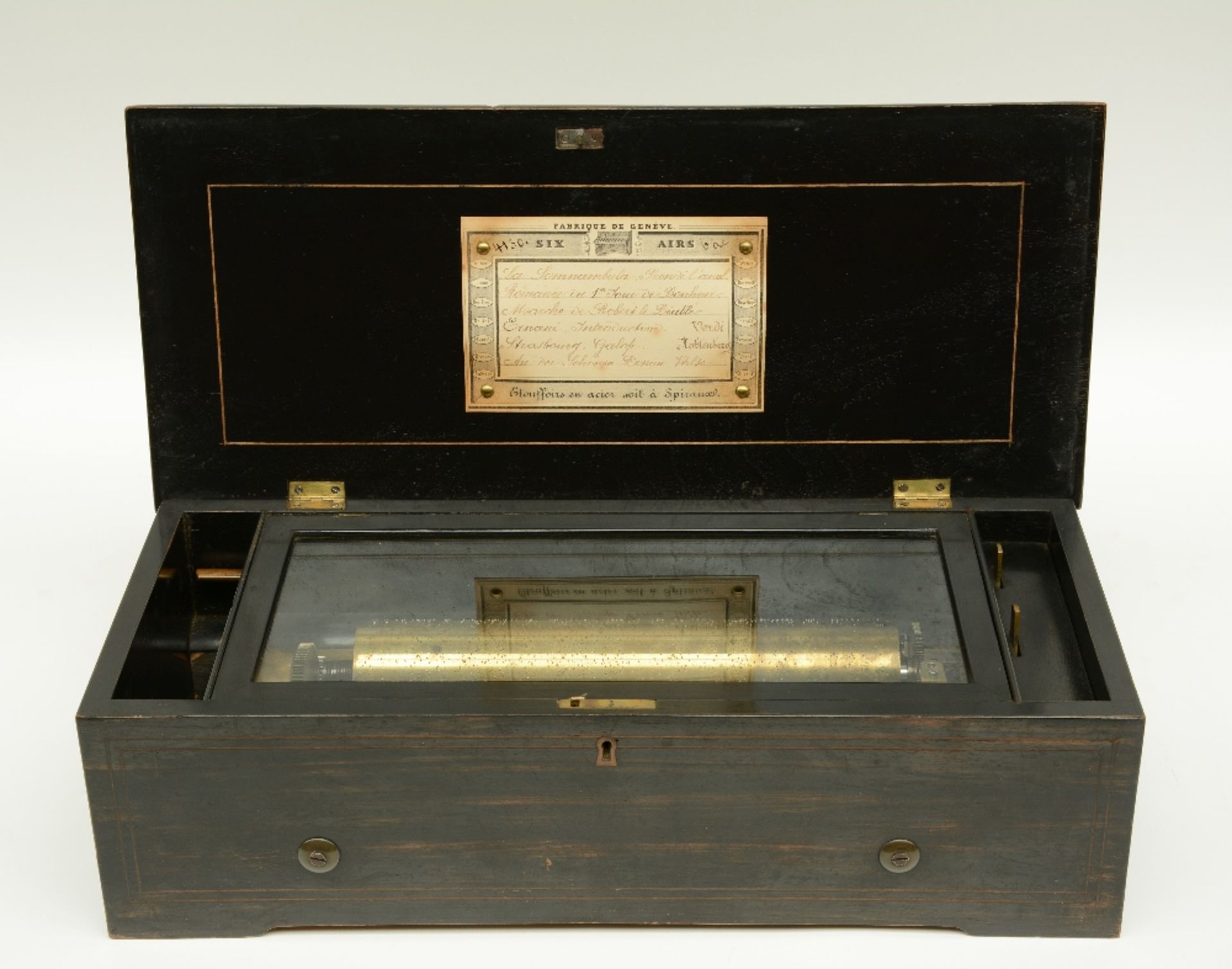 A 19thC ebonised and rosewood veneered music box, 'Fabrique de  Genève - Six Airs', H 14,5 - W 49,