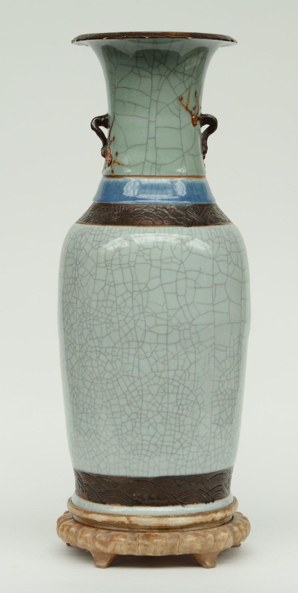 A Chinese stone- crackleware vase, relief decorated, on a matching wooden base, marked, ca. 19thC, H