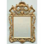 Richly carved gilt wooden early Rococo style mirror, H 99,5 - W 64 cm