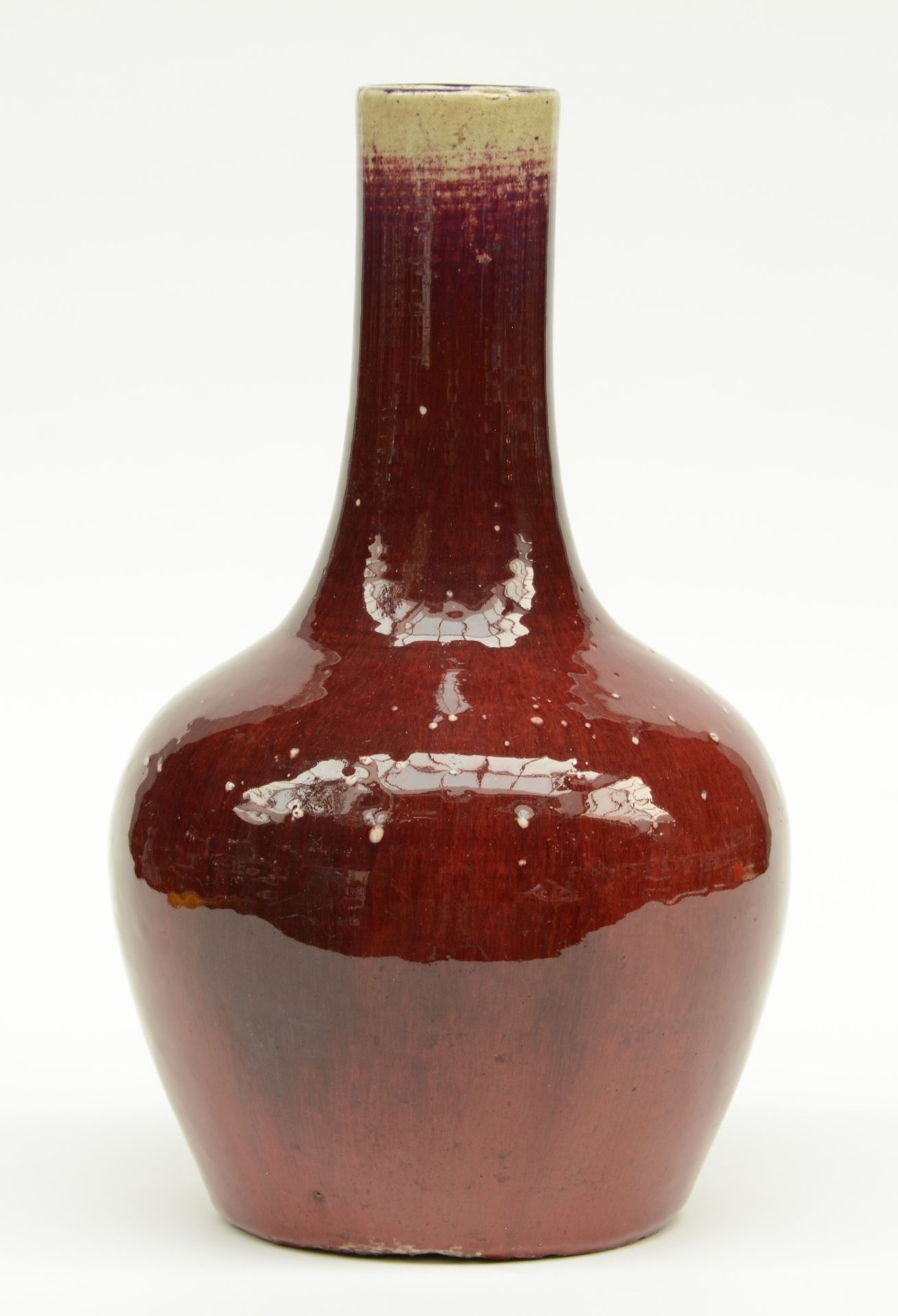 A Chinese sang de boeuf bottle vase, H 38,5 cm (chips on the bottom and a firing fault on the rim)