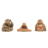 Three Japanese wooden katabori netsuke depicting a lady with hat; a jolly koto-player and an avid