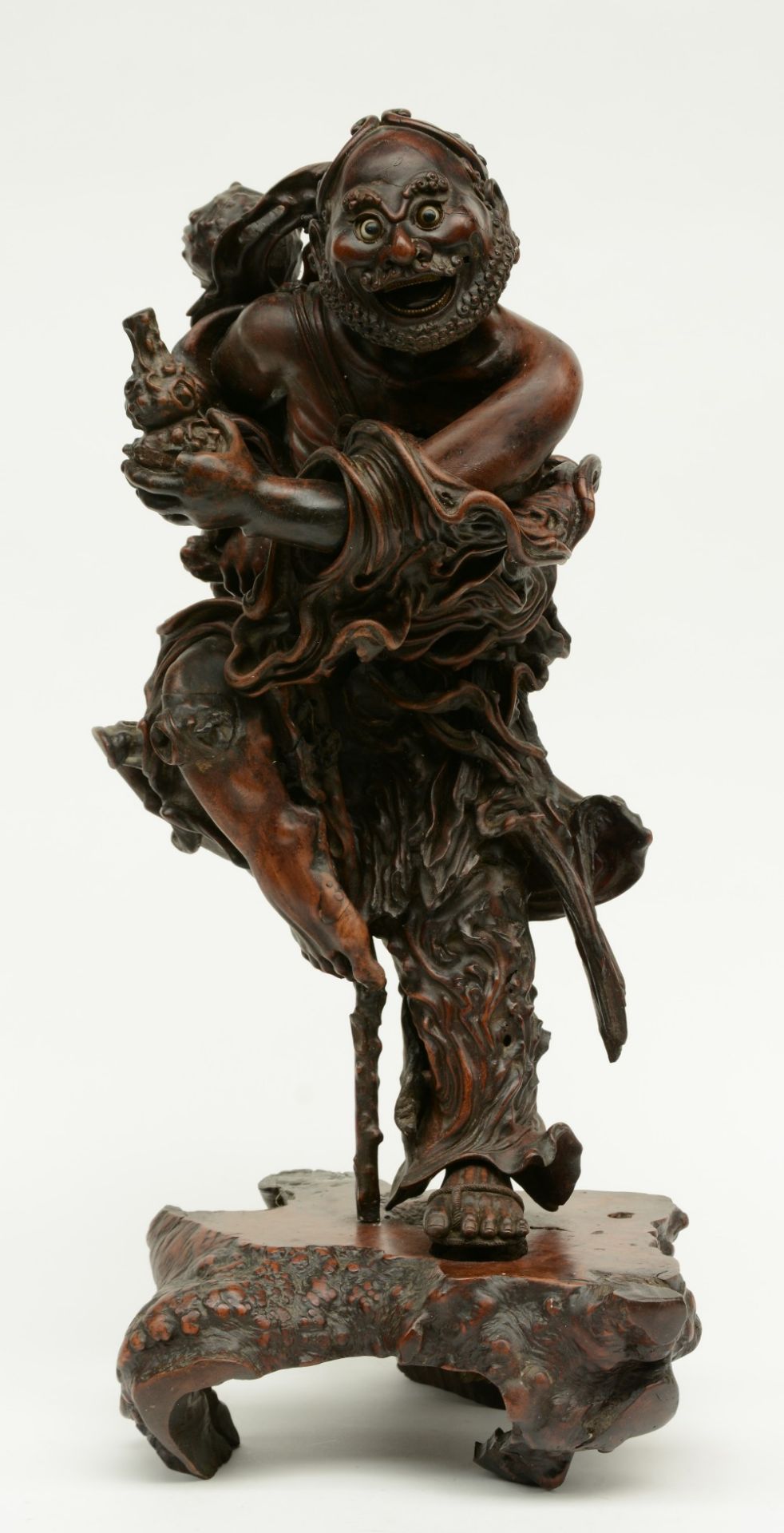 A Chinese walnut carved sculpture depicting a mythical figure, 19thC, H 64 cm (left indexfinger