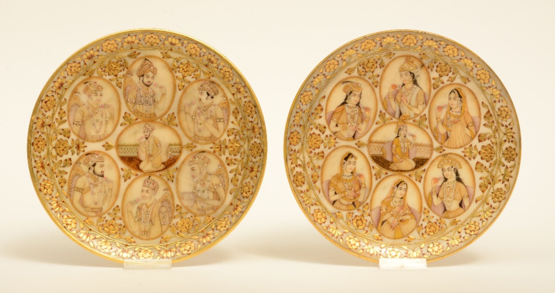 A rare pair of Moghul alabaster plaques, decorated with various portraits, each plaque surrounded by