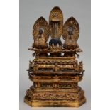 An 18thC Oriental gilt wooden temple with two sitting Buddha's on lotus seat and rich carvings, H 60