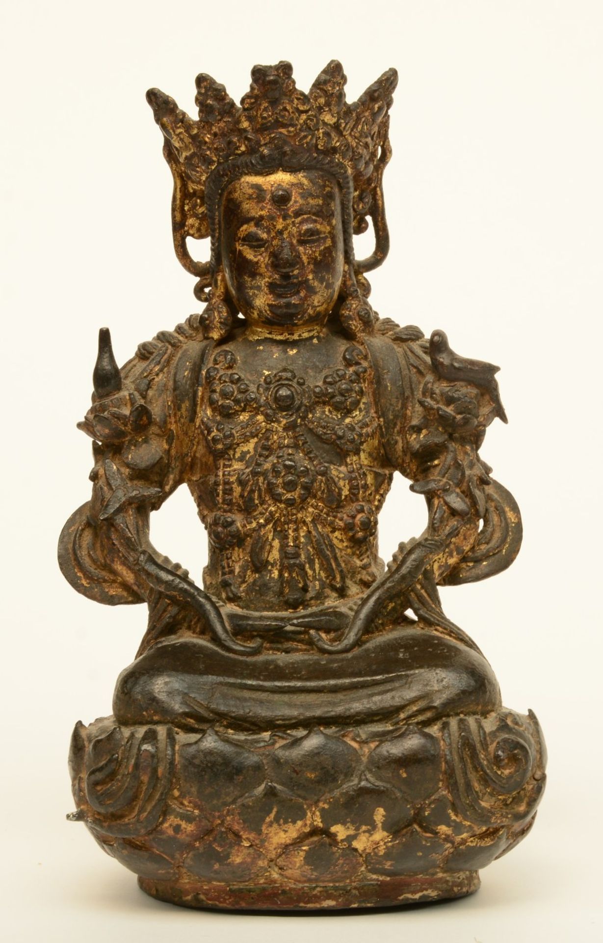 A Chinese gilt bronze Buddha, with polychrome traces, probably Ming, H 20 cm