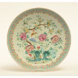 An Oriental famille rose plate with floral decoration, 19thC, Diameter 40 cm (chip on the rim)