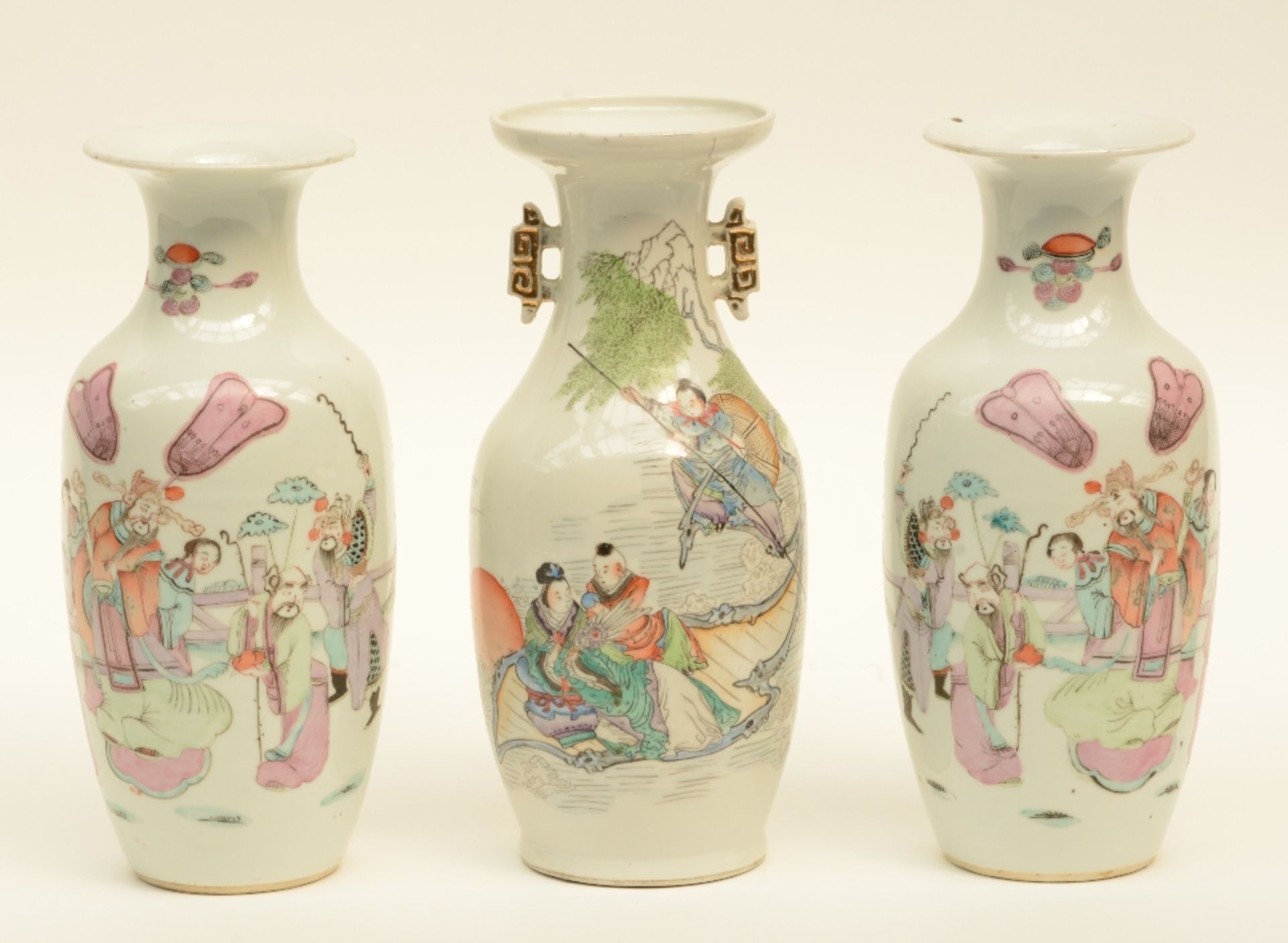 A Chinese pair of vases, polychrome decorated with an animated scene, marked; added a ditto vase,