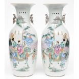 A pair of Chinese polychrome vases, depicting an animated scene, 19th C, H 58 cm, (minor hairline on