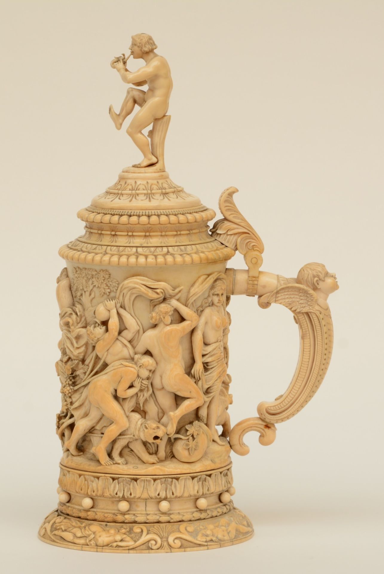 A rare German ivory Humpen, alto relievo sculpted with Bacchus on a chariot preceded by a drunken