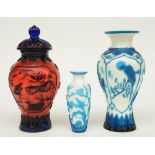 Two Chinese vases and a vase and cover, in colored and laminated glass, decorated with birds and