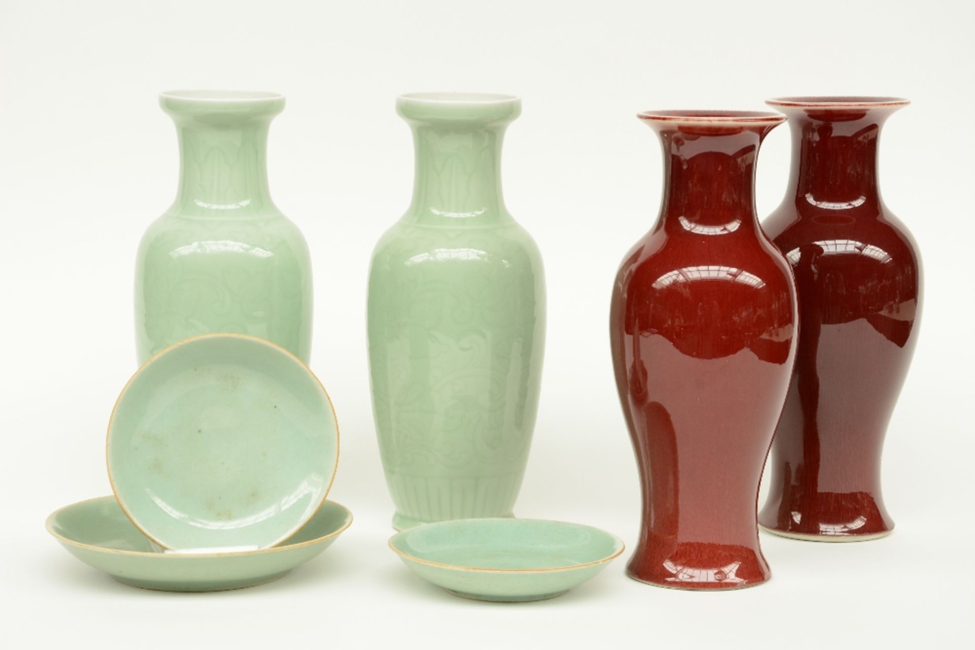 A pair of Chinese celadon vases and three ditto dishes, marked; added a pair of Chinese 'sang de