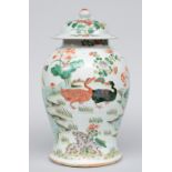 A Chinese famille verte vase with cover, decorated all around with ducks in a pond, 19thC, H 44