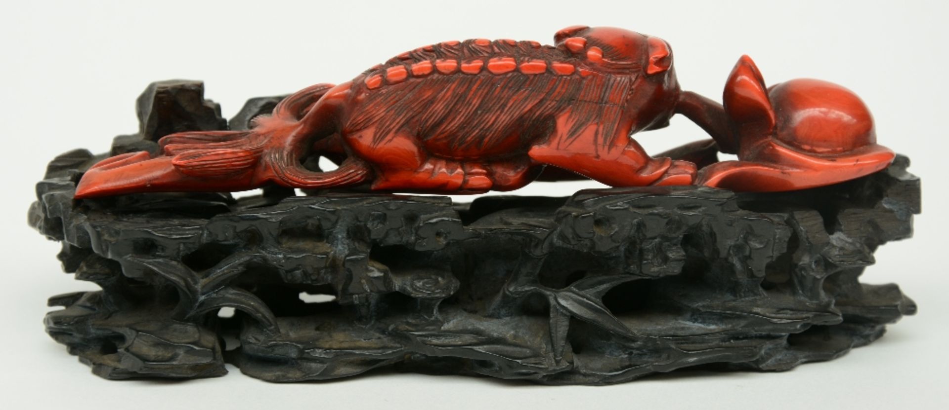 A Chinese monochrome red ivory sculpture depicting a mythological animal, on a wooden base, 19thC, H - Bild 3 aus 8